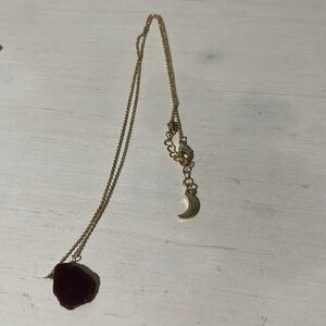 Gold necklace with purple stone